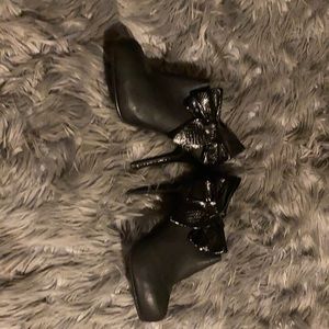 Black booties with faux snake skin bows